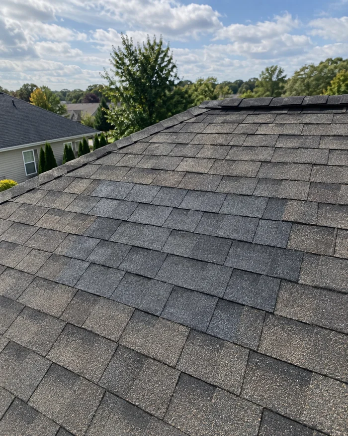 Roof section with new shingles blended into the old field after wind damage