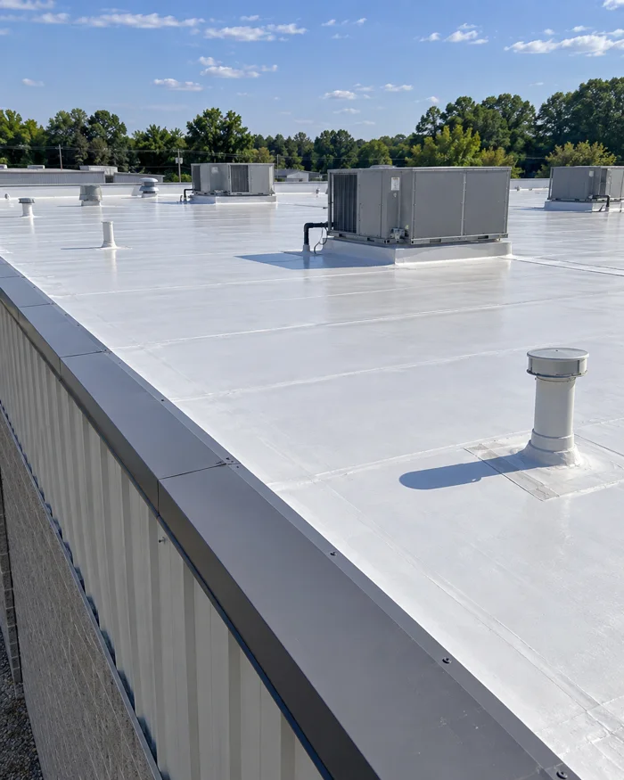 Low slope commercial building with a new roof membrane and edge metal
